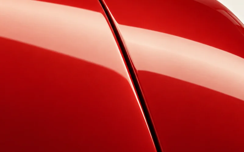 Close crop of the reflection crossing the same adjoining vermilion panels.
