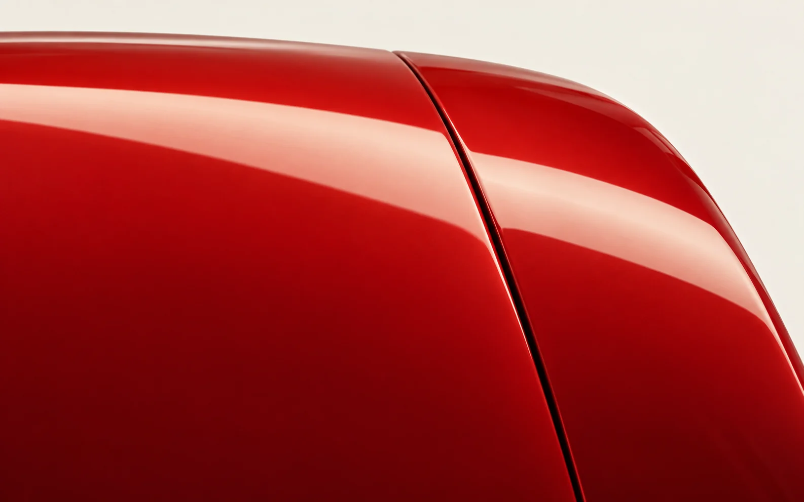 Conceptual view of adjoining vermilion panels with a light reflection crossing their seam.